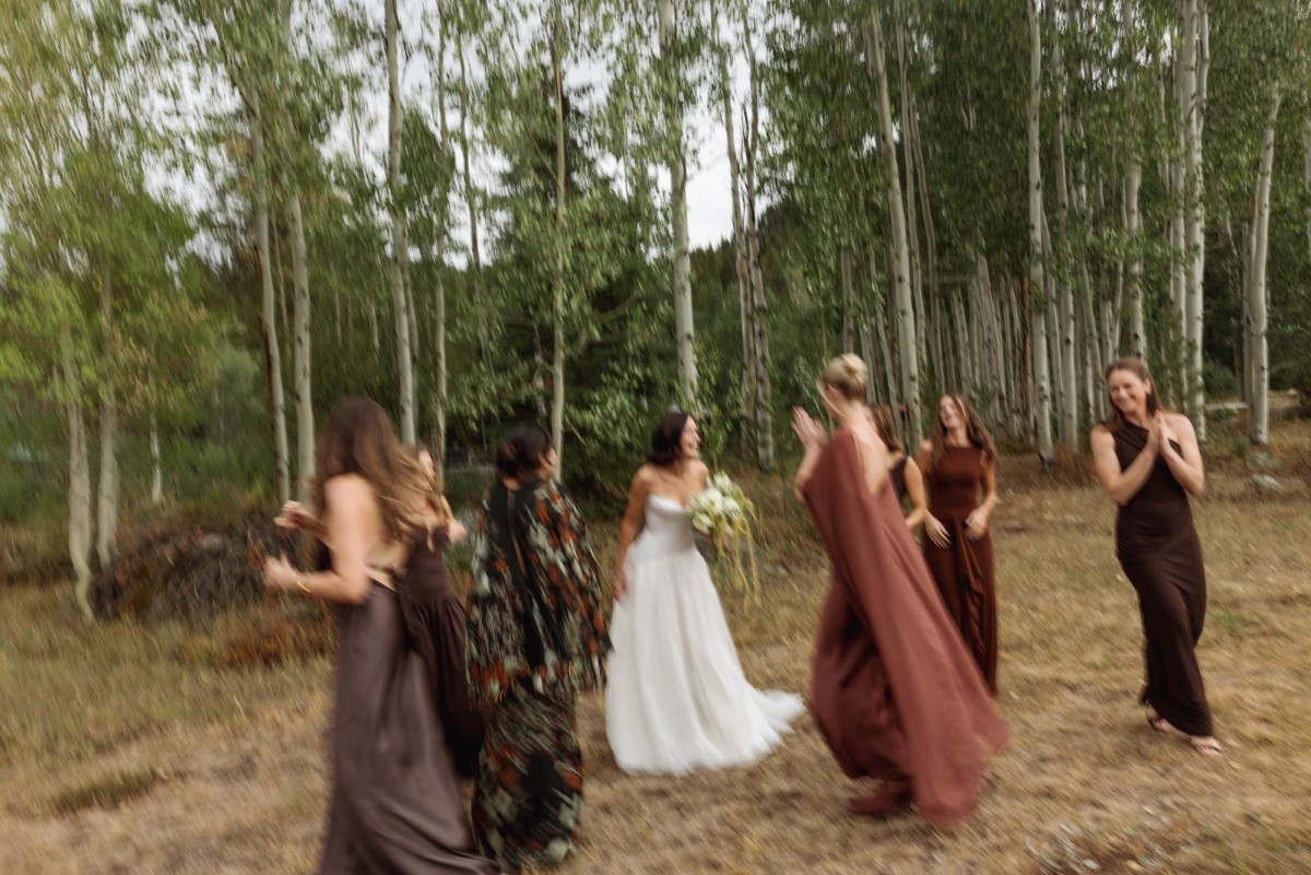 Devin's bridesmaids react as they see her in her gown among the aspens at a mountain ranch among the aspens