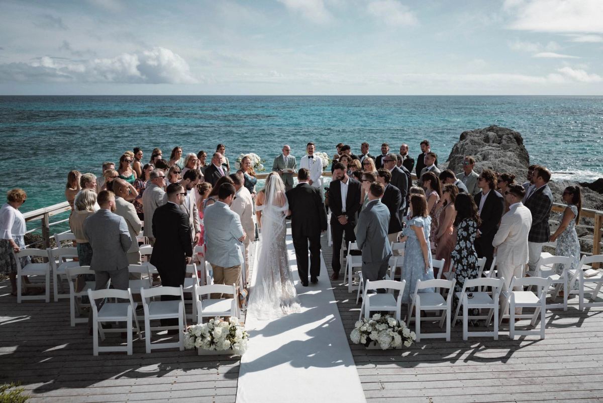 Epic wide aerial view of cliffside ceremony at oceanfront Bermuda wedding venue