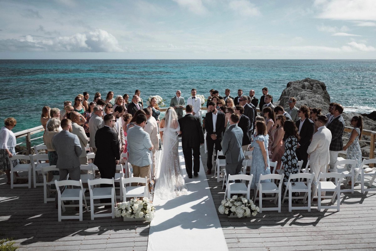 Epic wide aerial view of cliffside ceremony at oceanfront Bermuda wedding venue