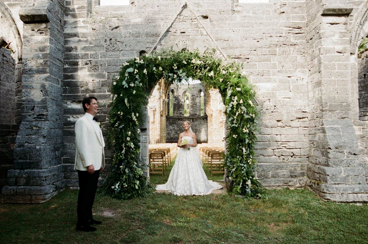 Bride and groom at the greenery arch inside the Bermuda church ruins, shot on film