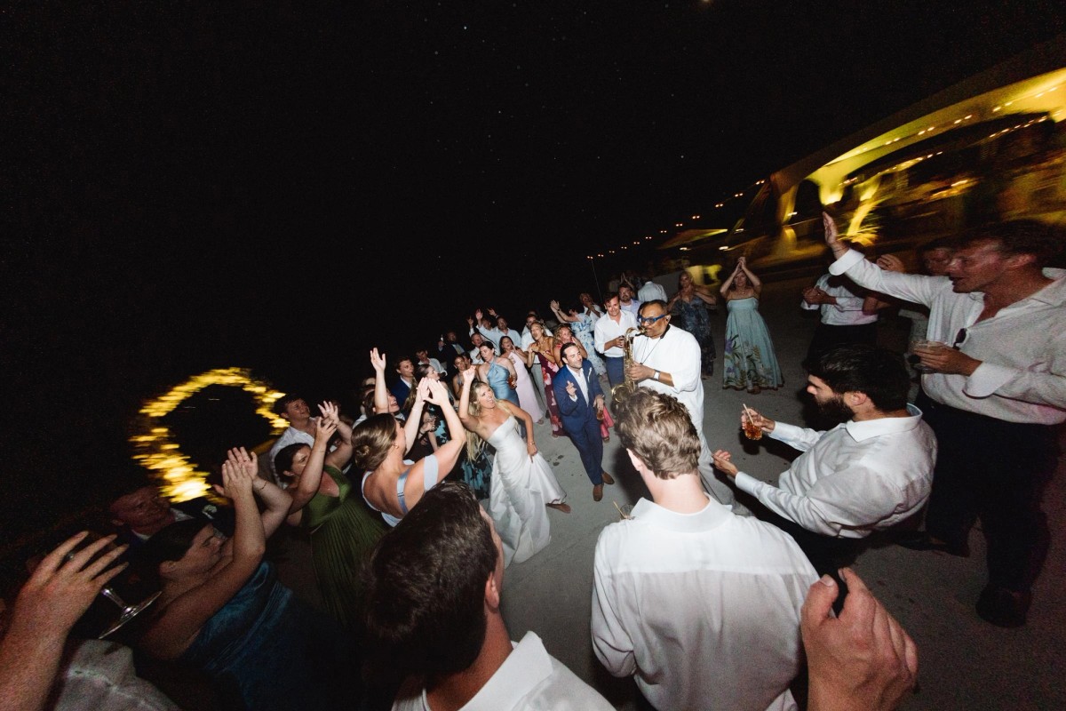 Guests crowd around Paige and Cam for a late night send off on Hawkins Island, Bermuda
