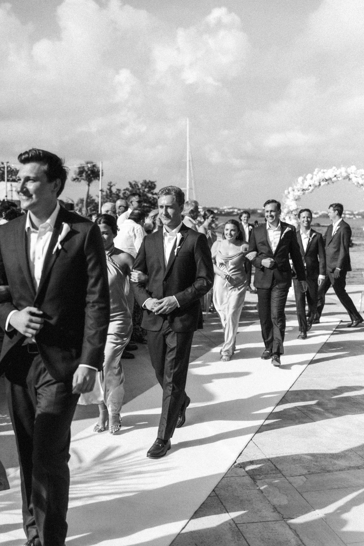 Groomsmen follow down the aisle after the ceremony on Hawkins Island, Bermuda, black and white