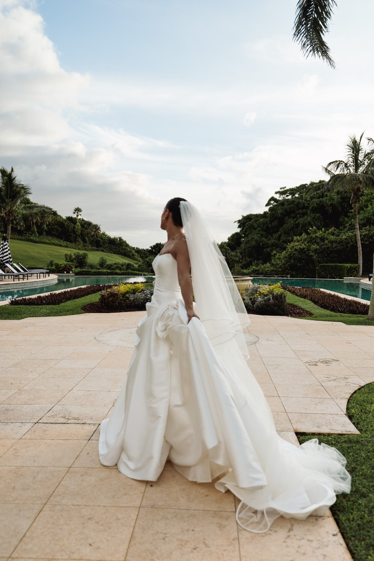 Bride looking out over the pool and gardens toward the sea at Rosewood Bermuda