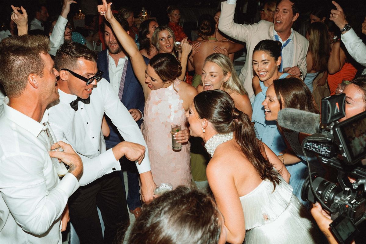 Packed dance floor of guests cheering and dancing late into the night