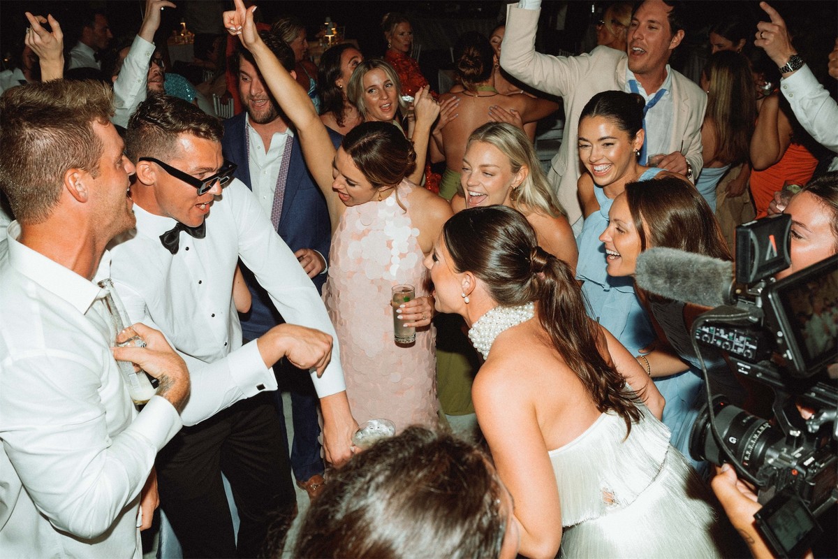 Packed dance floor of guests cheering and dancing late into the night