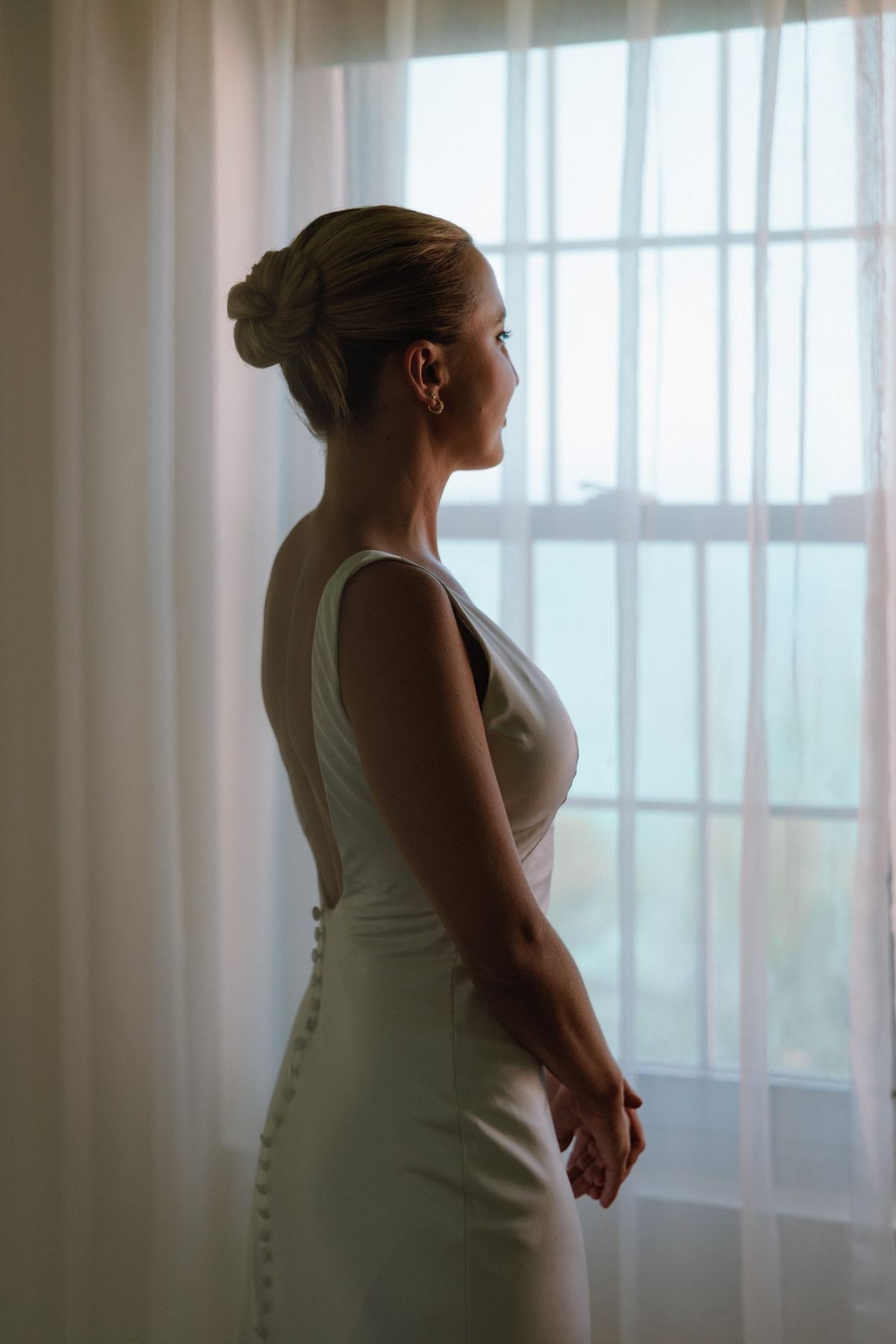 Bride in soft window light during getting ready at a Bermuda wedding
