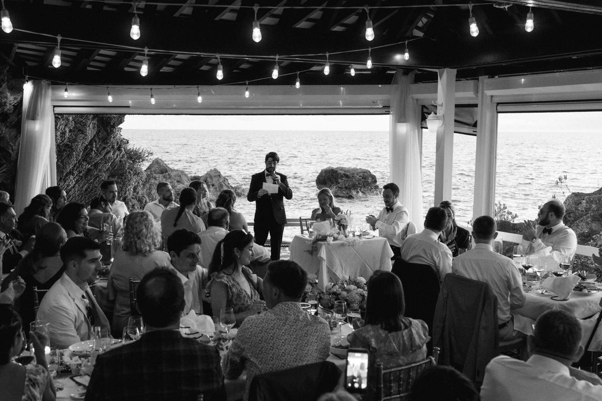 Cinematic wide of Bermuda wedding reception under string lights