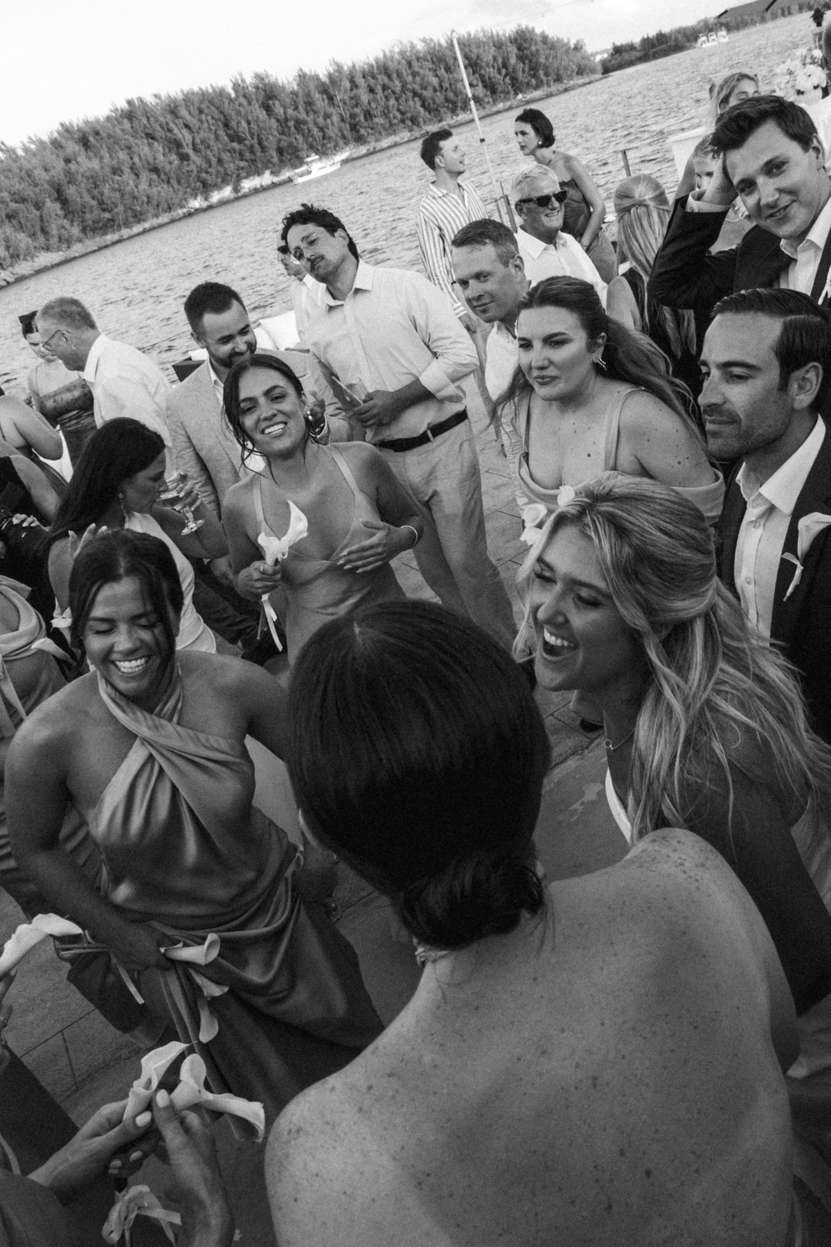 Bridesmaids pack the dance floor laughing on Hawkins Island, Bermuda, black and white