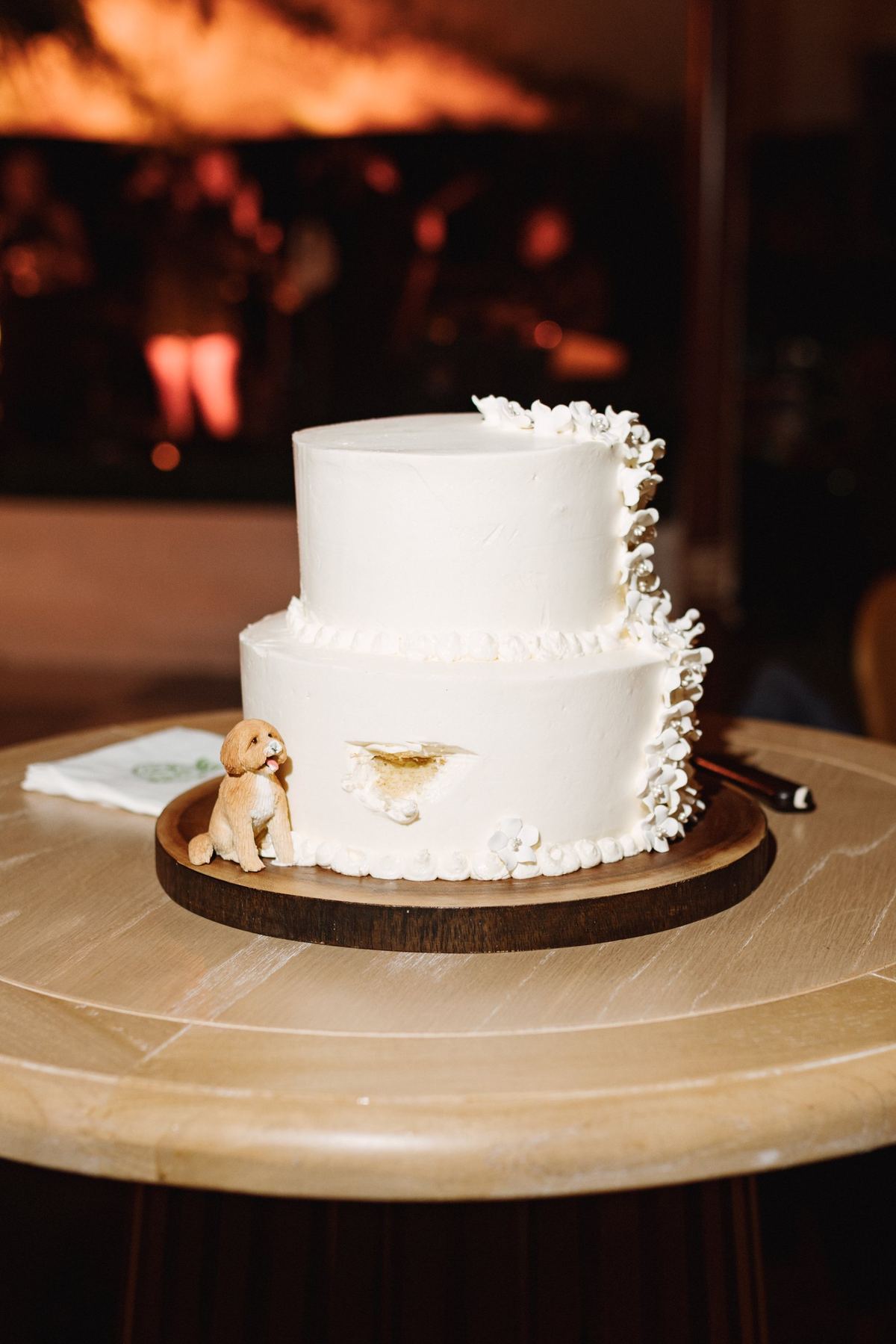 Simple white wedding cake in warm light at a Bermuda reception