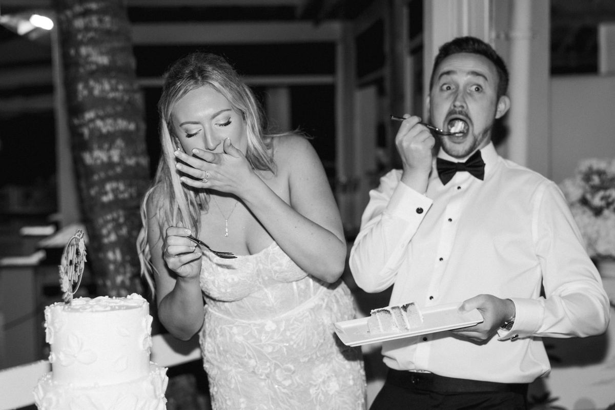 Bride and groom funny faces during cake cutting at Bermuda wedding