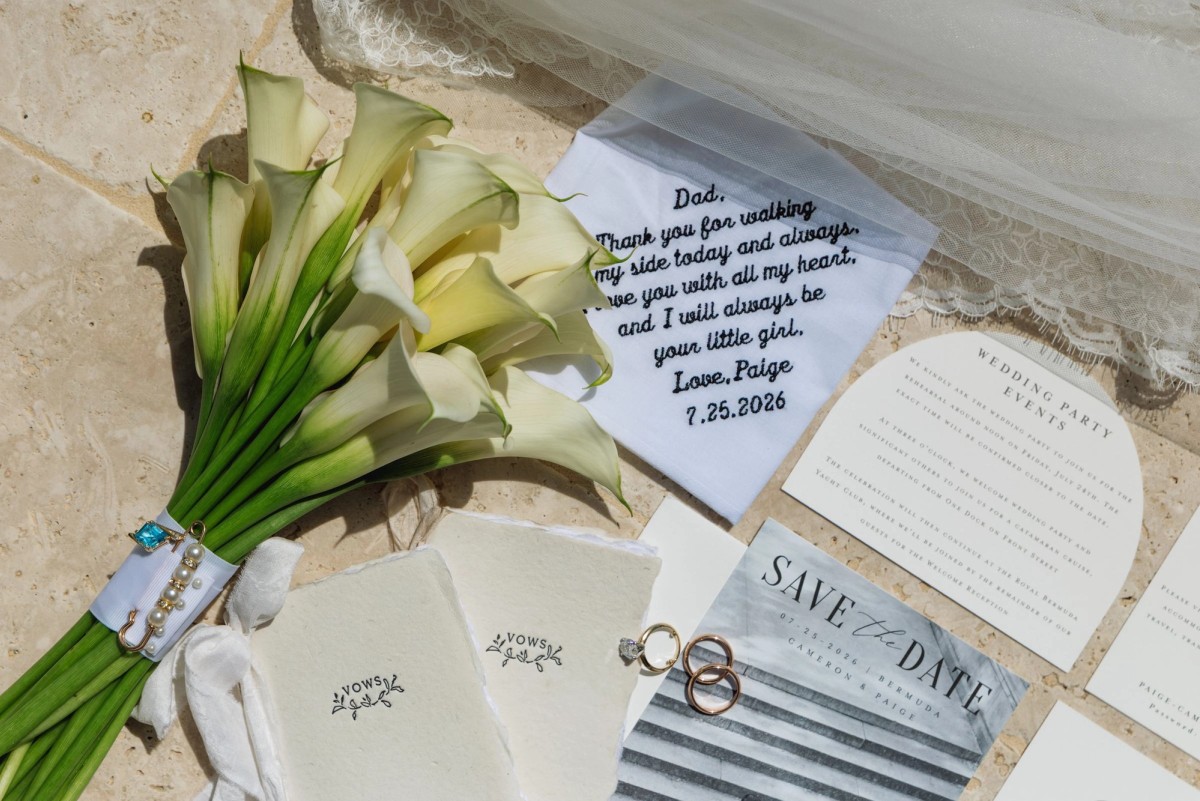 Calla lily bouquet, rings, invitations and a note to Dad laid on the stone on Hawkins Island, Bermuda