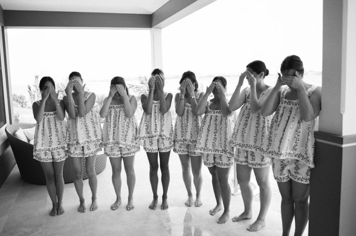 Bridesmaids cover their eyes on the porch before seeing Paige in her dress on Hawkins Island, Bermuda, black and white