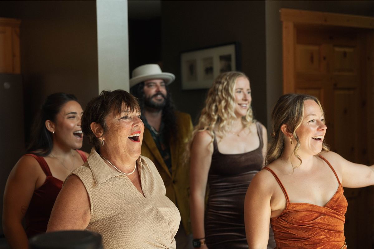 Guests laughing together as they watch the couple during the celebration