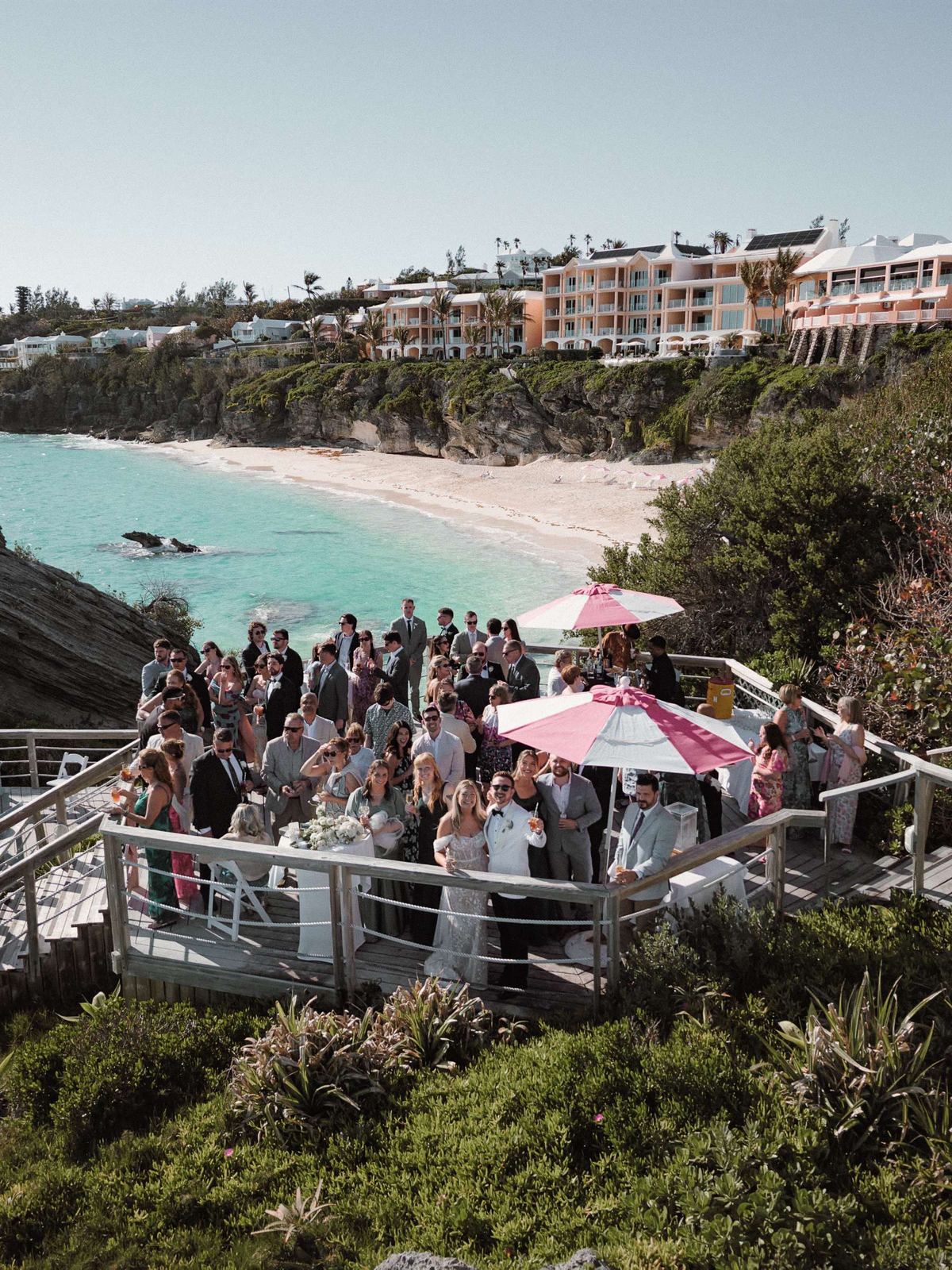 Wide environmental view of cliffside cocktail hour at oceanfront Bermuda wedding