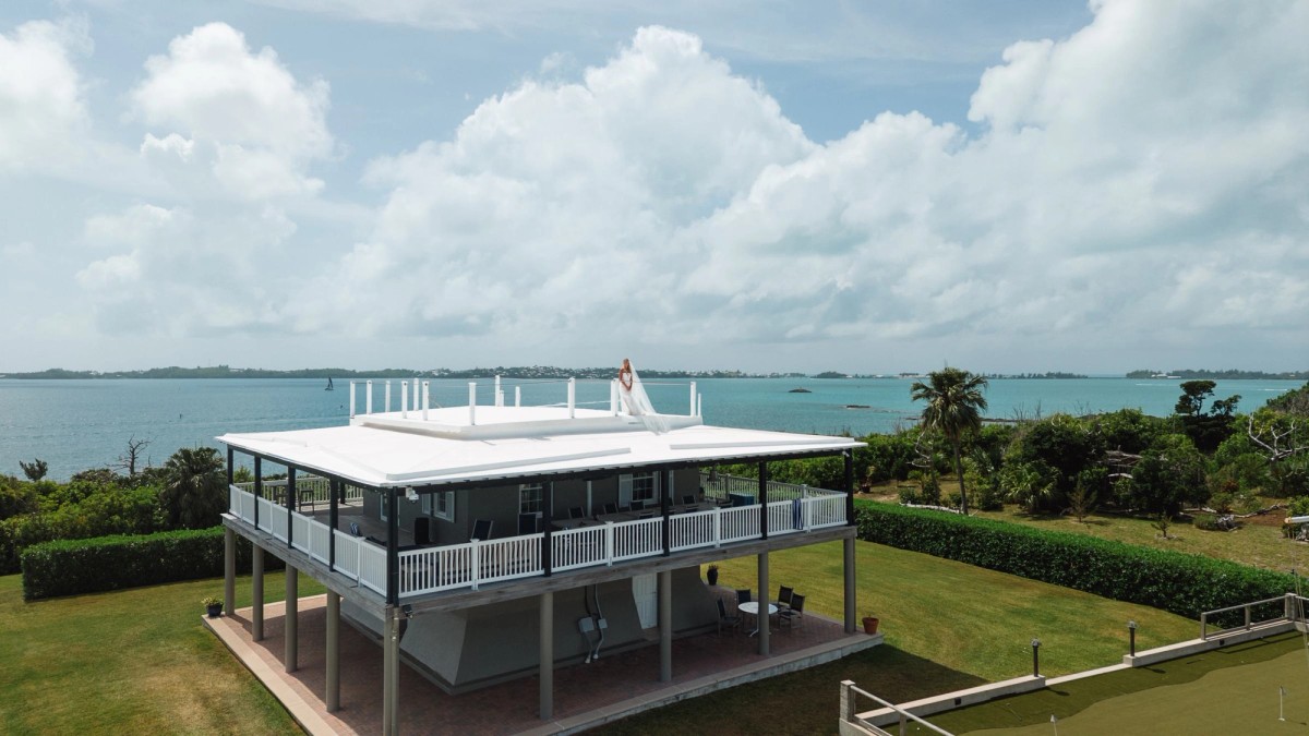 Paige on the rooftop of the waterfront house with the bay stretching out behind on Hawkins Island, Bermuda