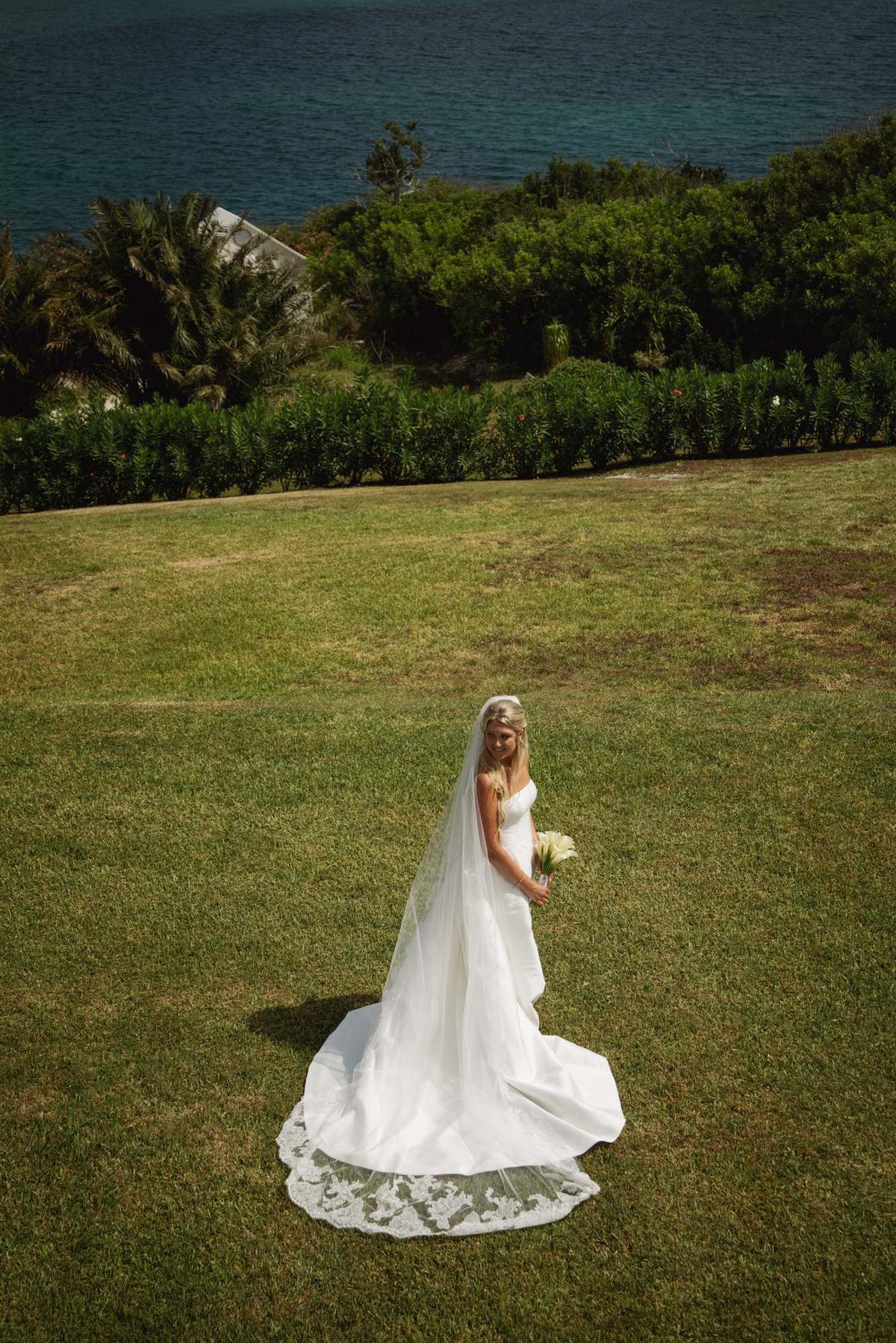 Paige looks back over her shoulder on the open lawn above the water on Hawkins Island, Bermuda