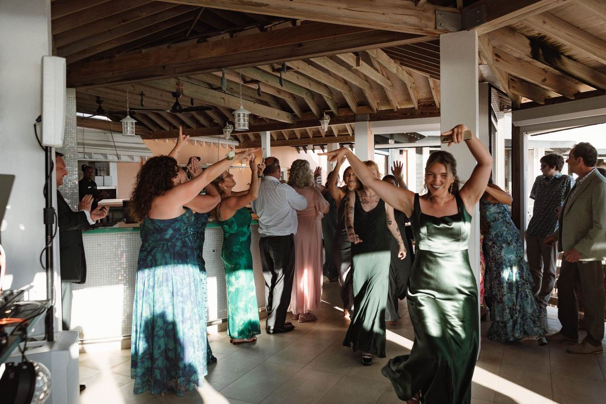 Bridesmaids entrance with hands raised at Bermuda wedding reception