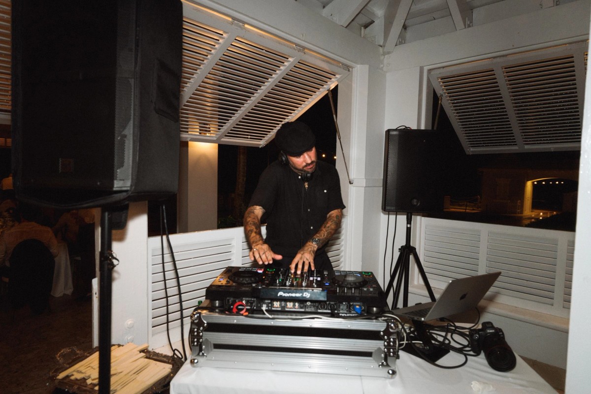 DJ at the decks on the covered terrace late in the night at Rosewood Bermuda