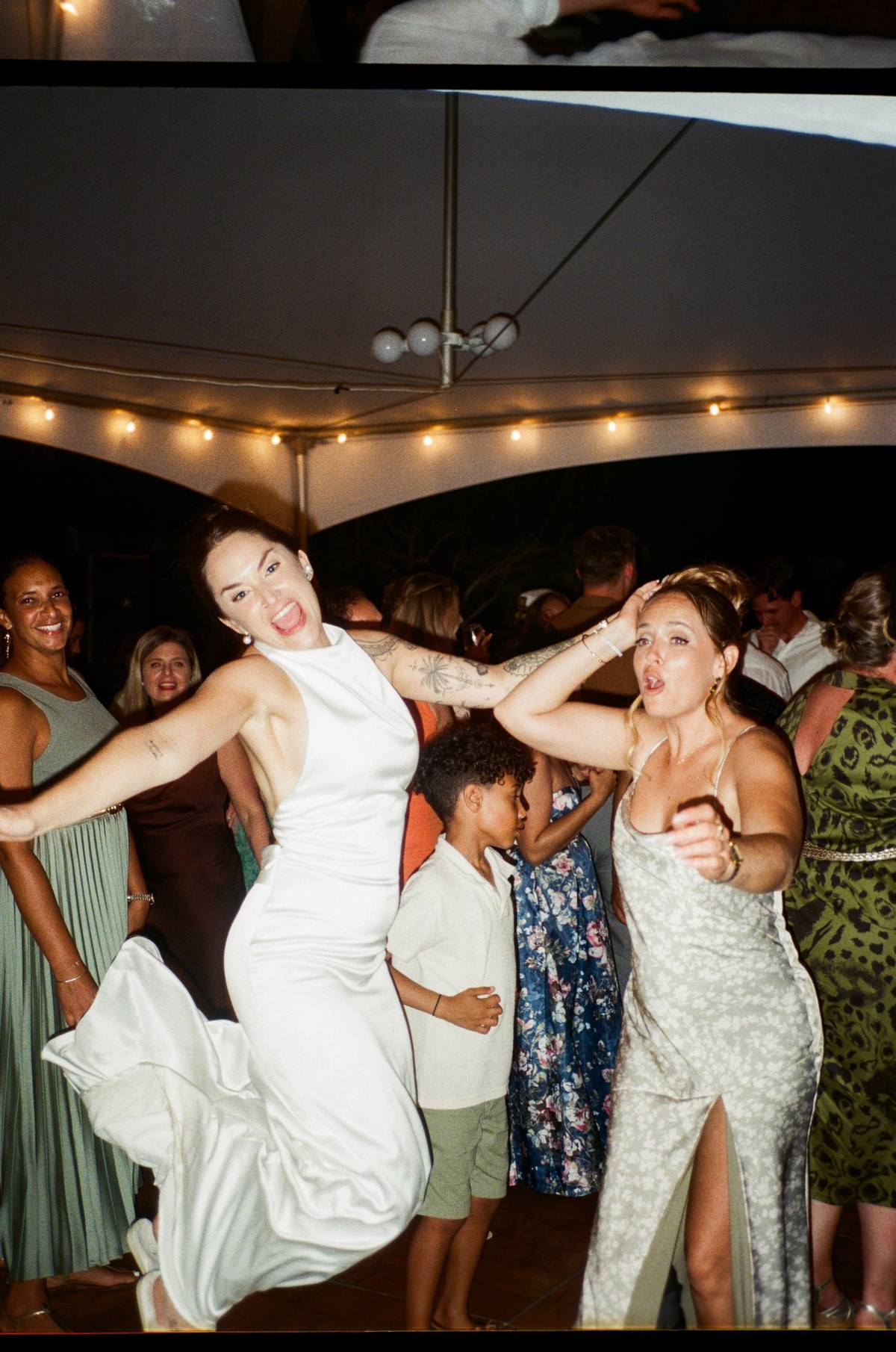 Bride dancing in the middle of the reception, shot on film