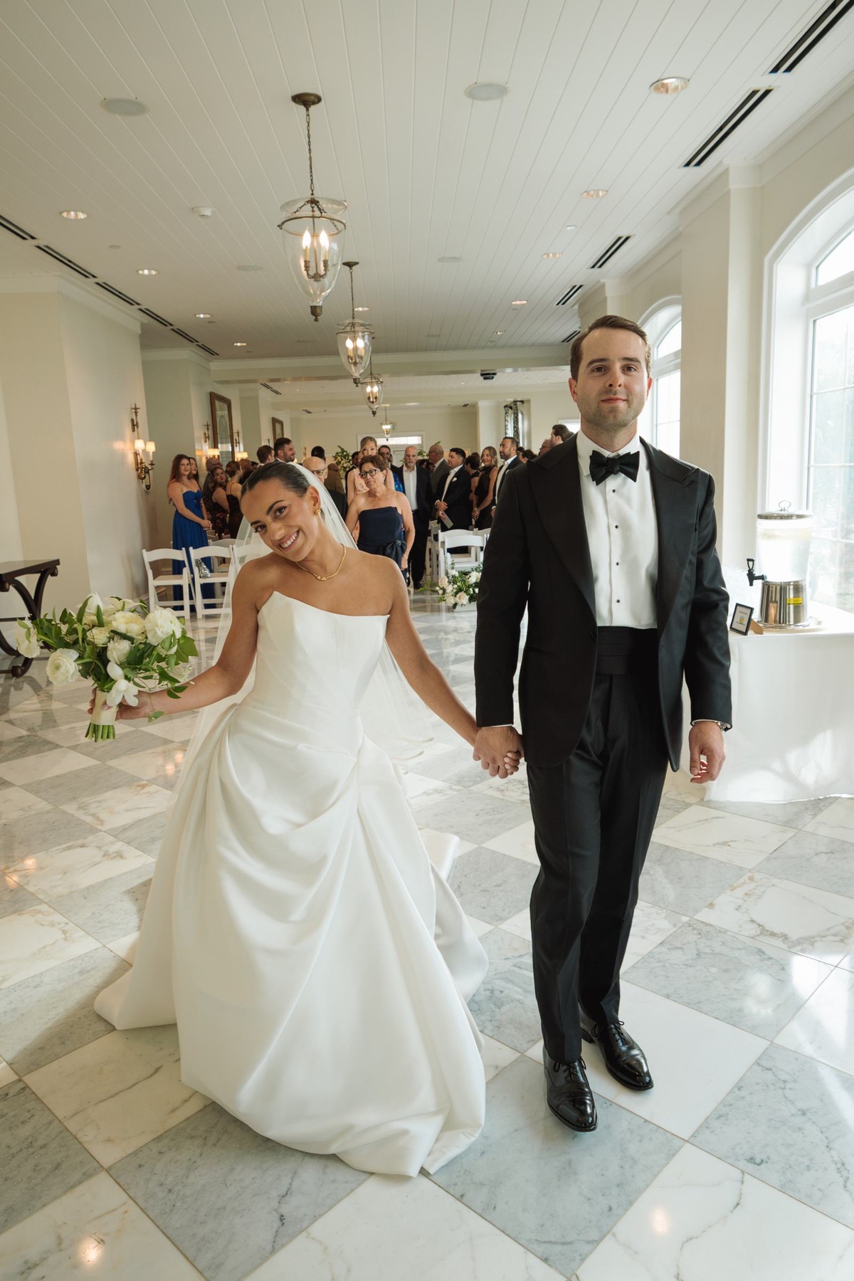 Newlyweds walking back up the aisle hand in hand at Rosewood Bermuda