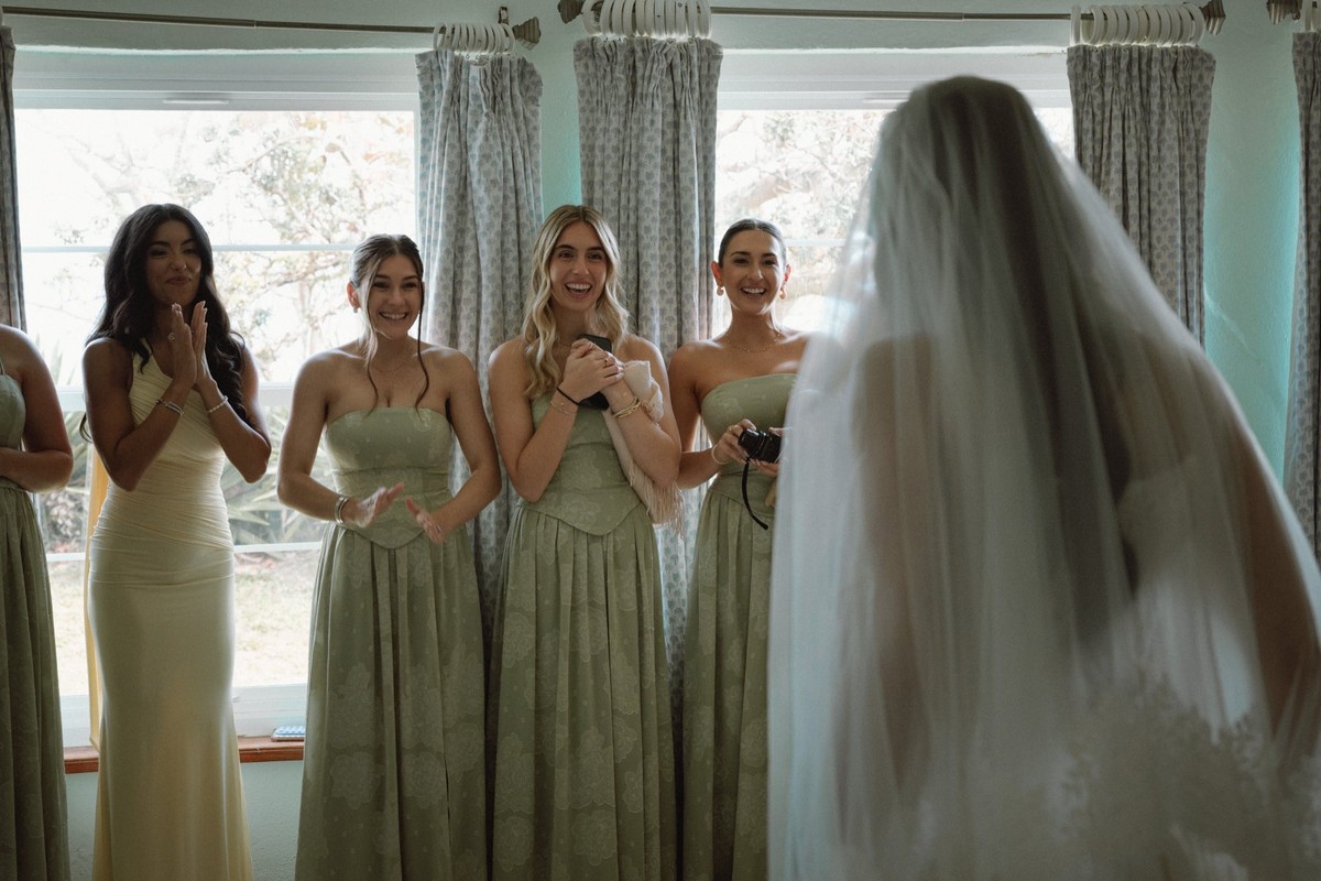 Bridesmaids' first look reaction as bride is revealed during preparation