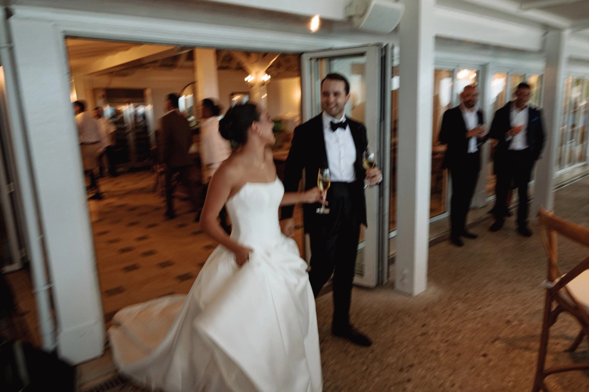 Couple arriving at the reception with champagne in hand at Rosewood Bermuda