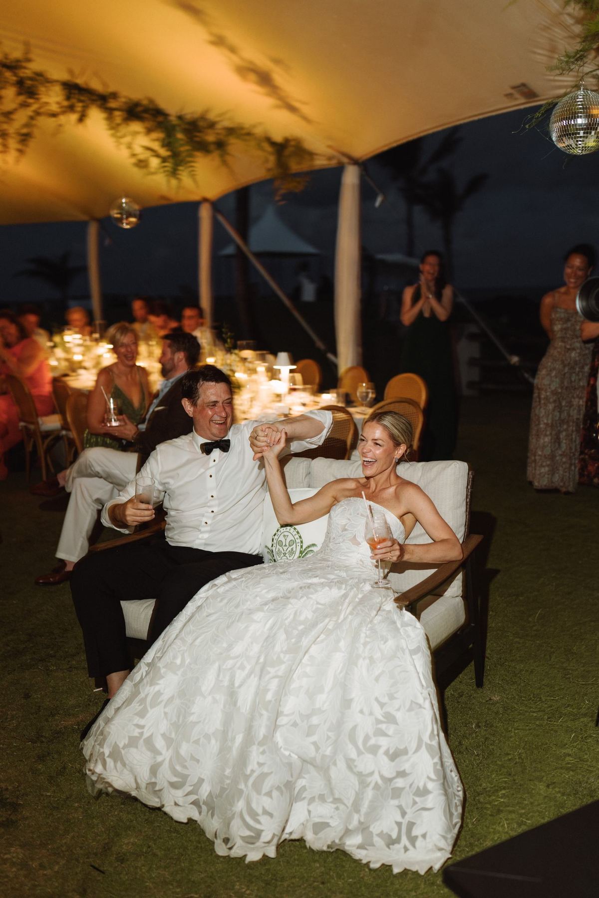 Bride and groom sitting together during the speeches at their Bermuda reception