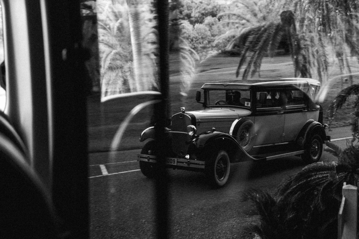 Vintage car seen through a shadowed window at Rosewood Bermuda, black and white