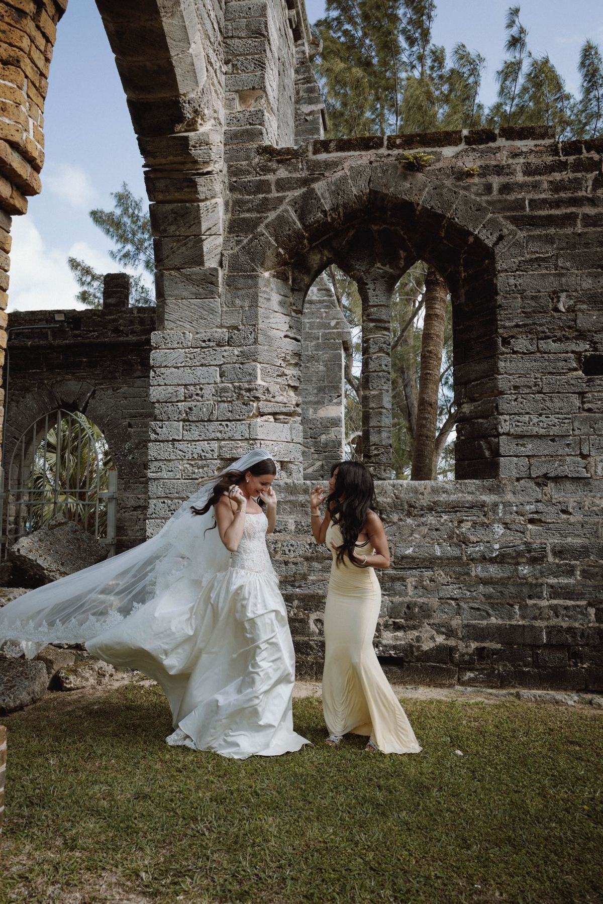 Playful candid of bride at historic Bermuda church ruins venue