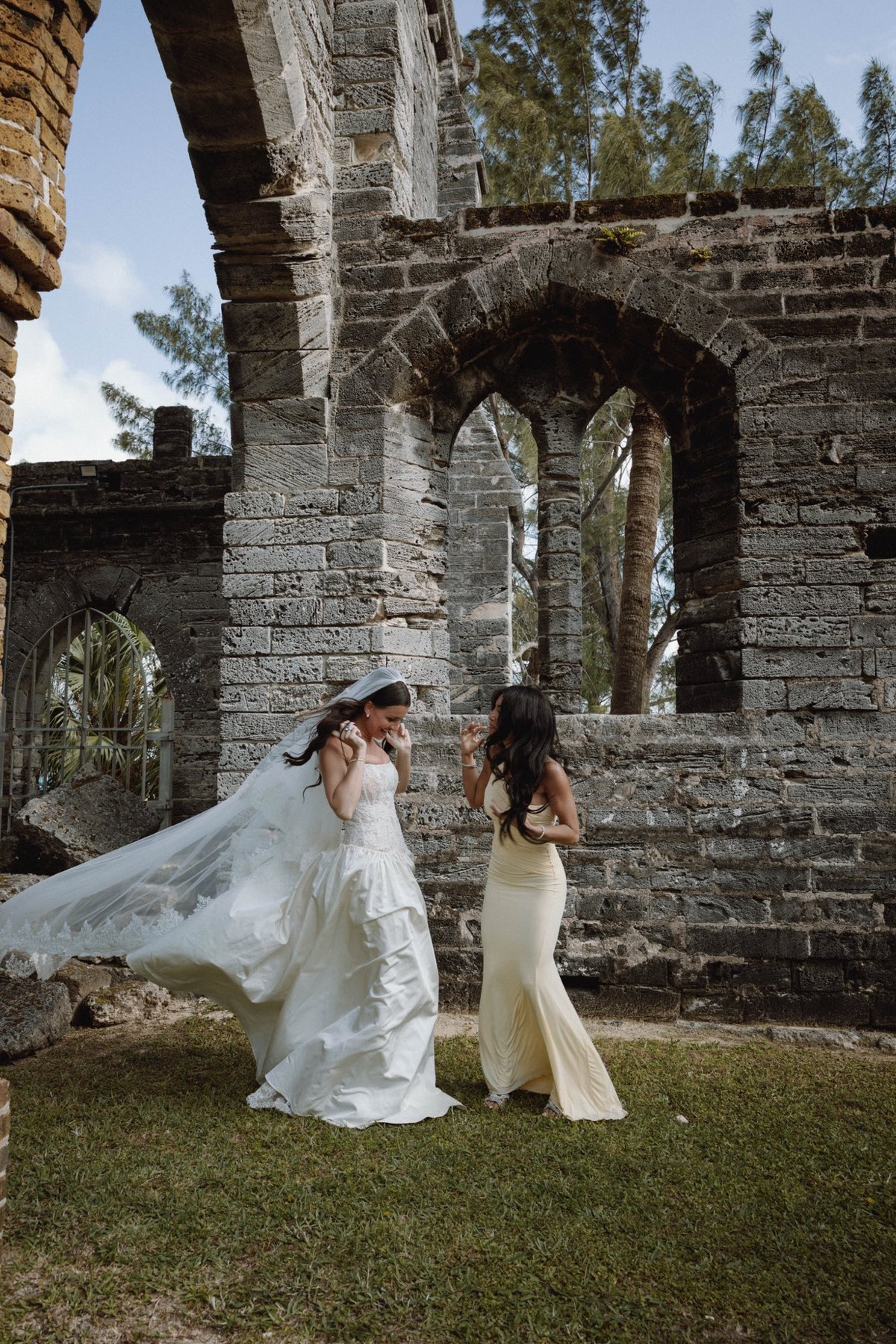 Playful candid of bride at historic Bermuda church ruins venue