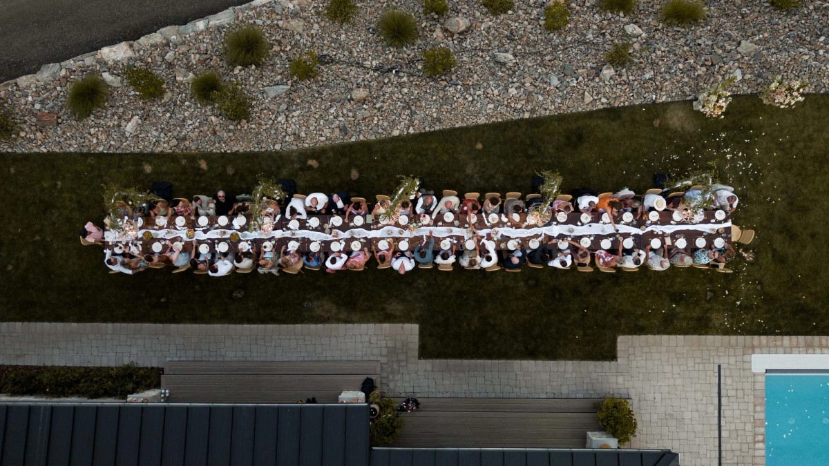 Aerial view of the long reception table with all the guests seated