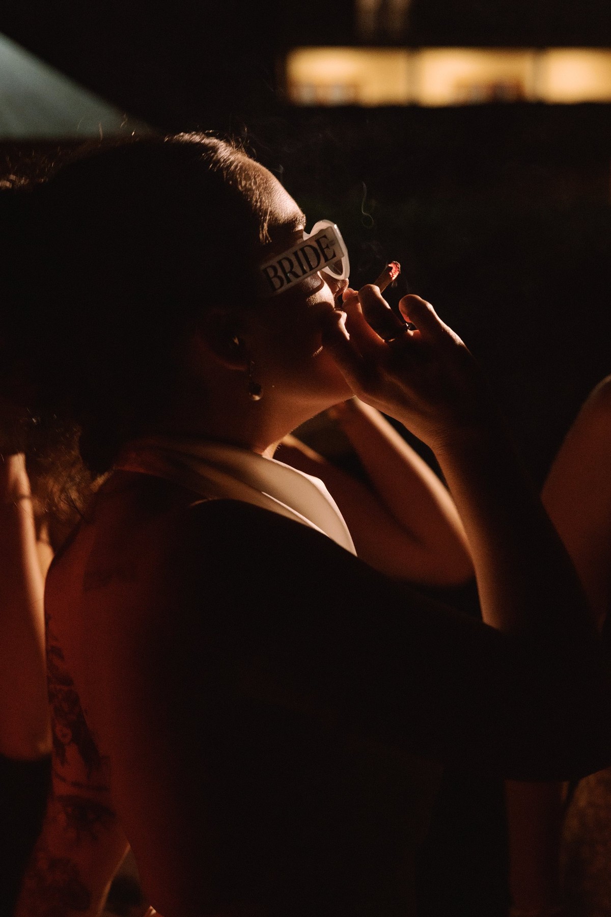 Moody photograph of the bride wearing a bride tiara in the dark