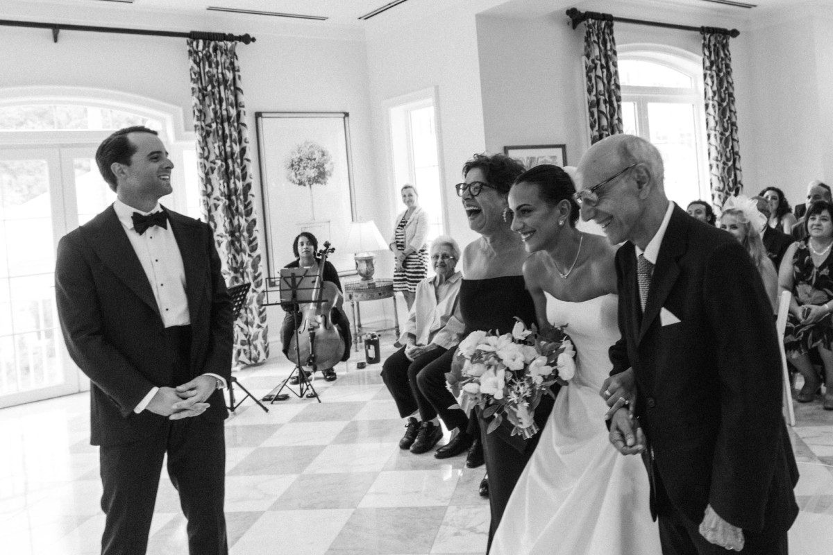 Groom beaming as the bride arrives at the altar at Rosewood Bermuda, black and white