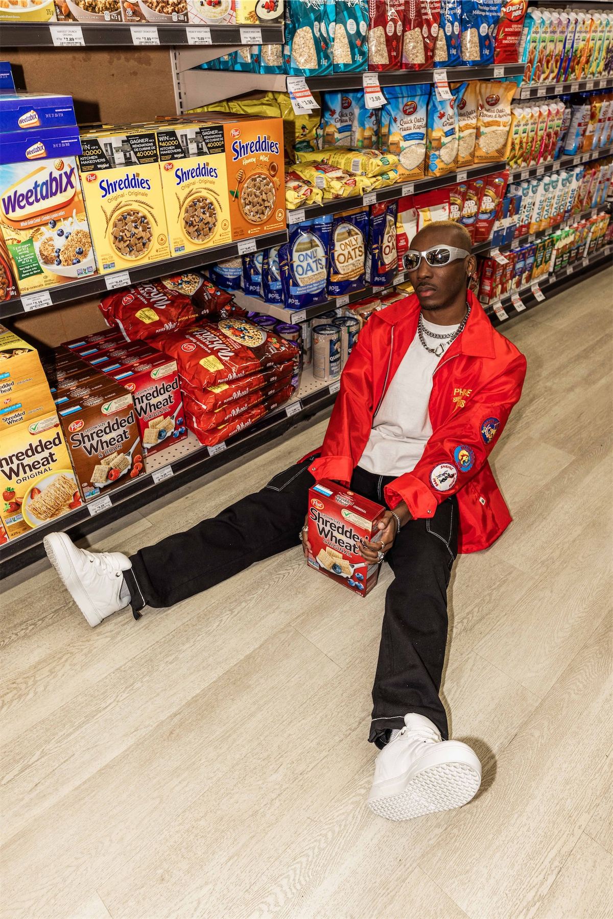 Model in a red leather jacket sitting on the floor of the cereal aisle