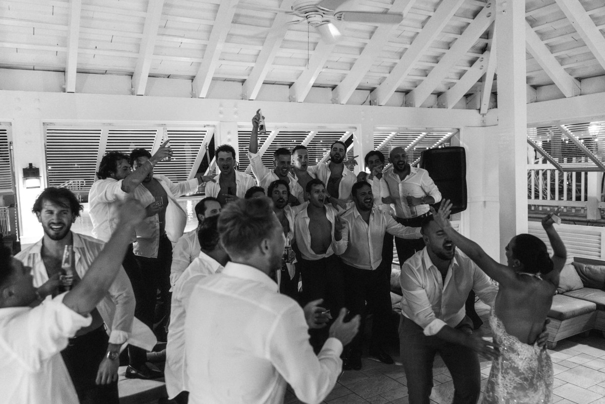 Guests jumping on the dance floor at Rosewood Bermuda, black and white