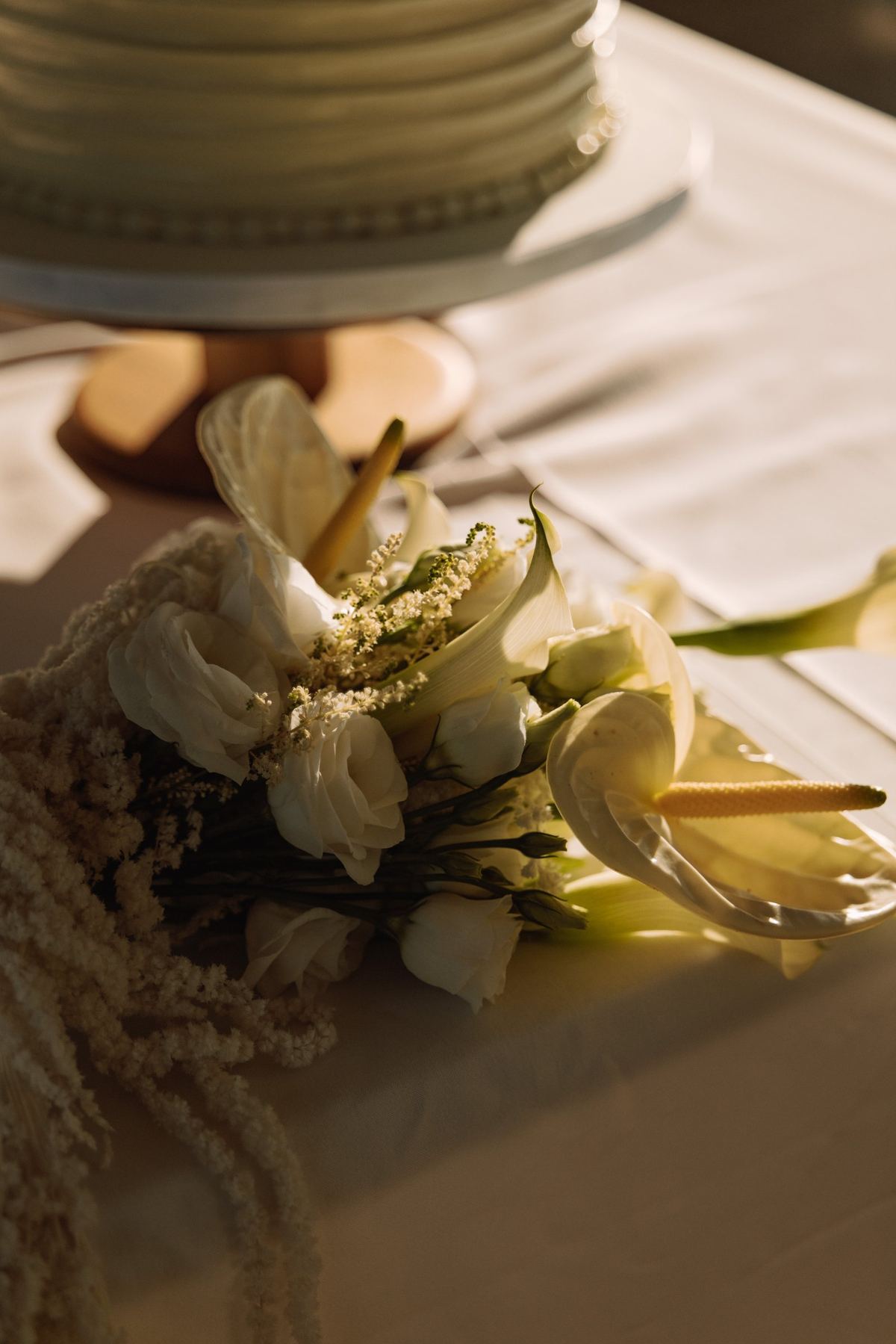 Place setting detail with white florals at a Bermuda wedding reception