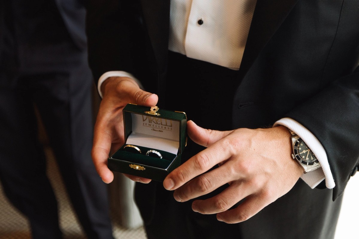 Groom holding the wedding bands in a green ring box at Rosewood Bermuda