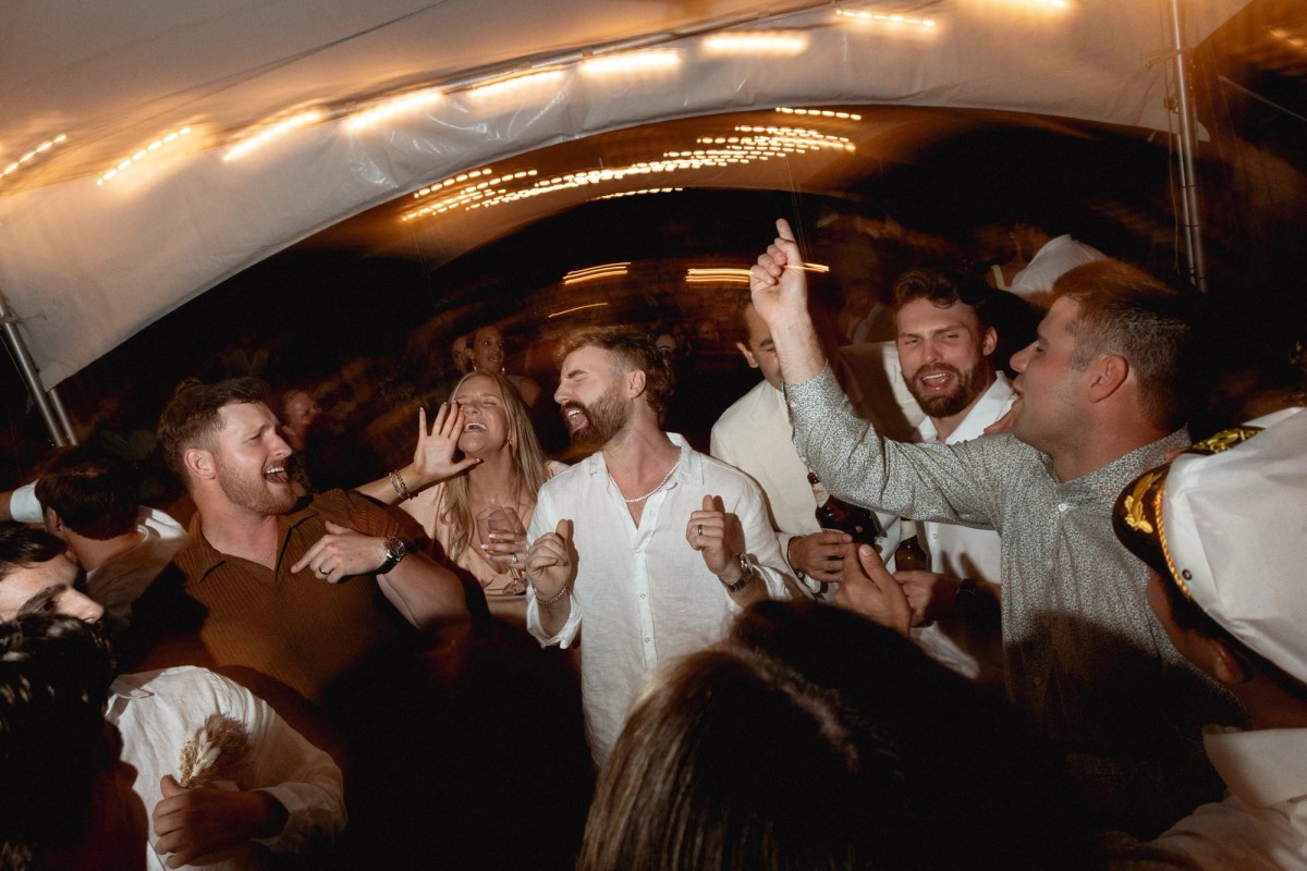 Guests packed on the dance floor under the tent, shot on film