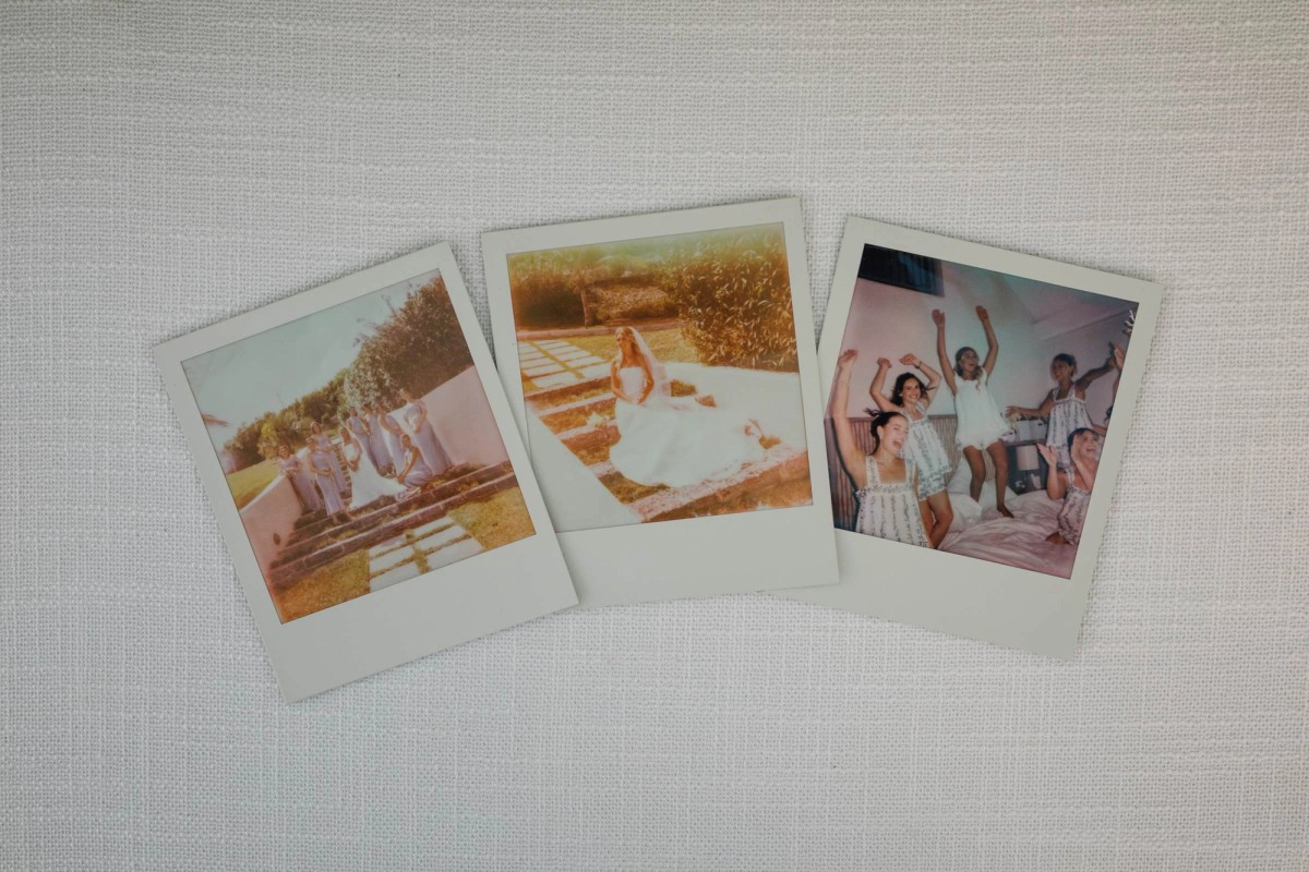 Instant photos from the wedding day laid out on the table linen on Hawkins Island, Bermuda