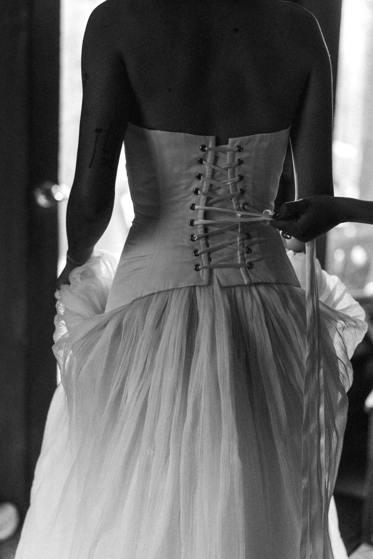 The corset of Devin's gown laced up the back at a mountain ranch among the aspens, black and white