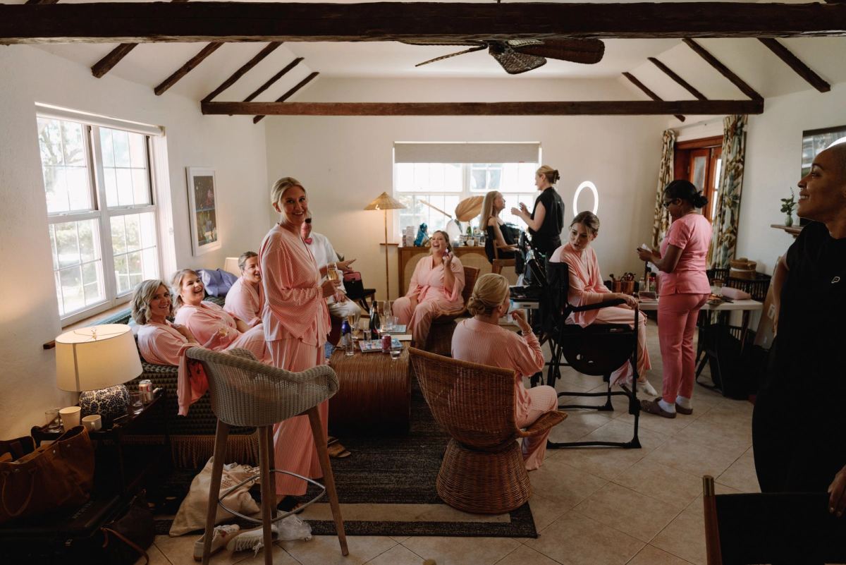 Wide getting ready room with bridesmaids in pink pyjamas at a Bermuda beach cottage