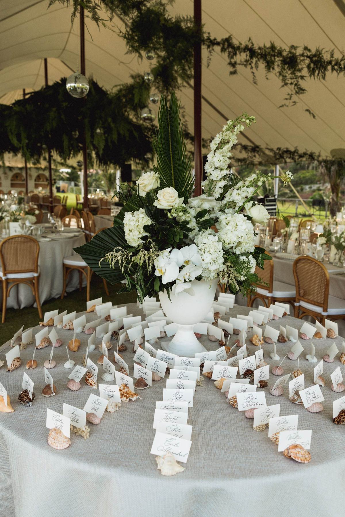 Escort card table dressed with white florals at a Bermuda wedding