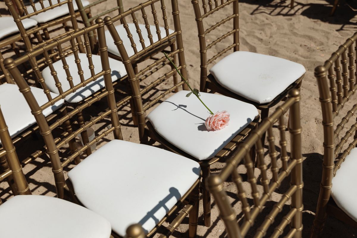 Floral detail on ceremony chair at elegant outdoor wedding