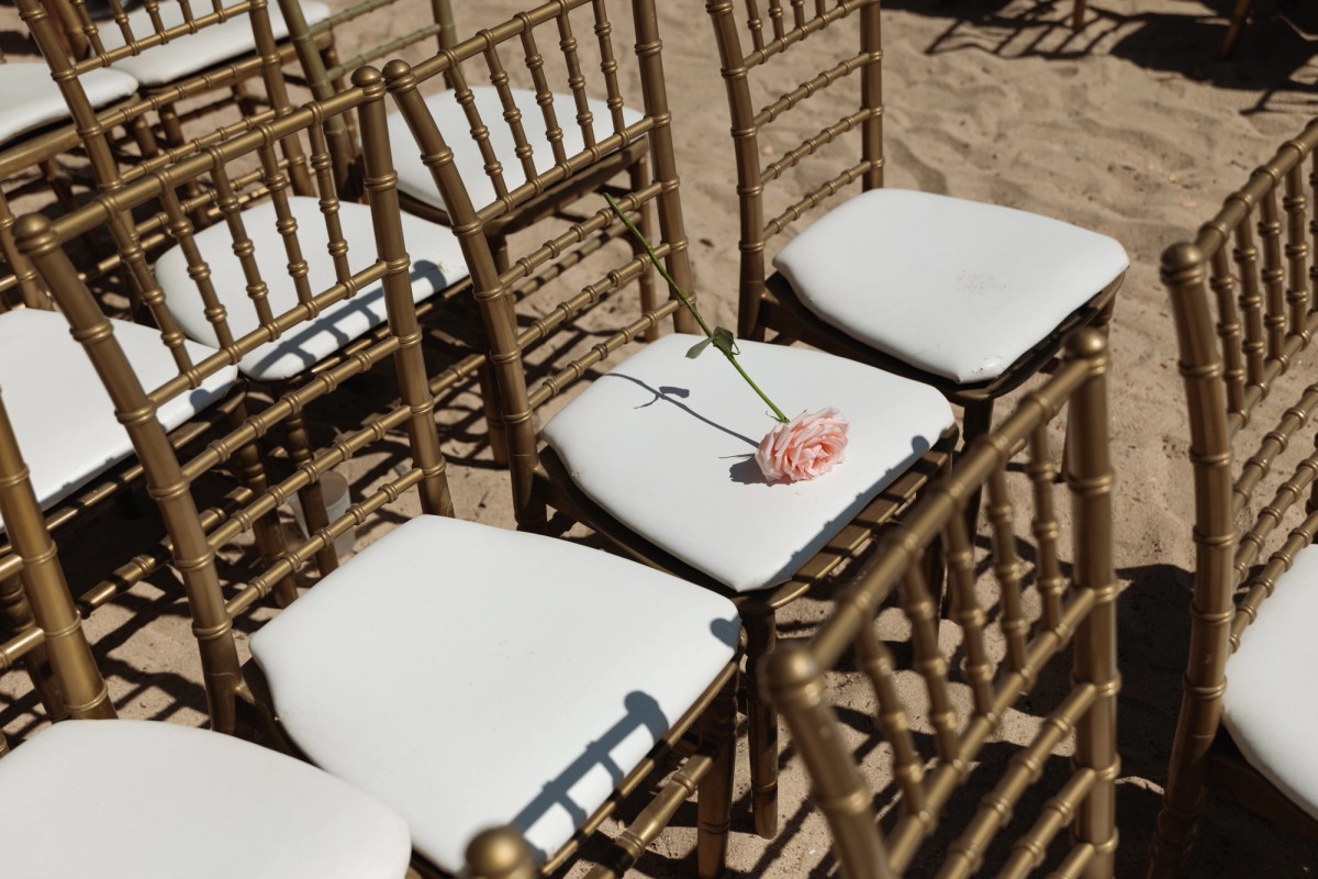 Floral detail on ceremony chair at elegant outdoor wedding