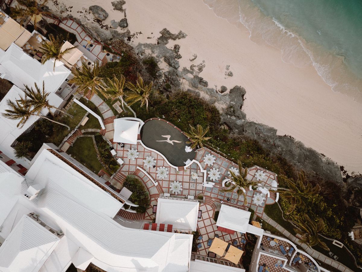 Aerial view of coastal Bermuda wedding reception layout on cliffside