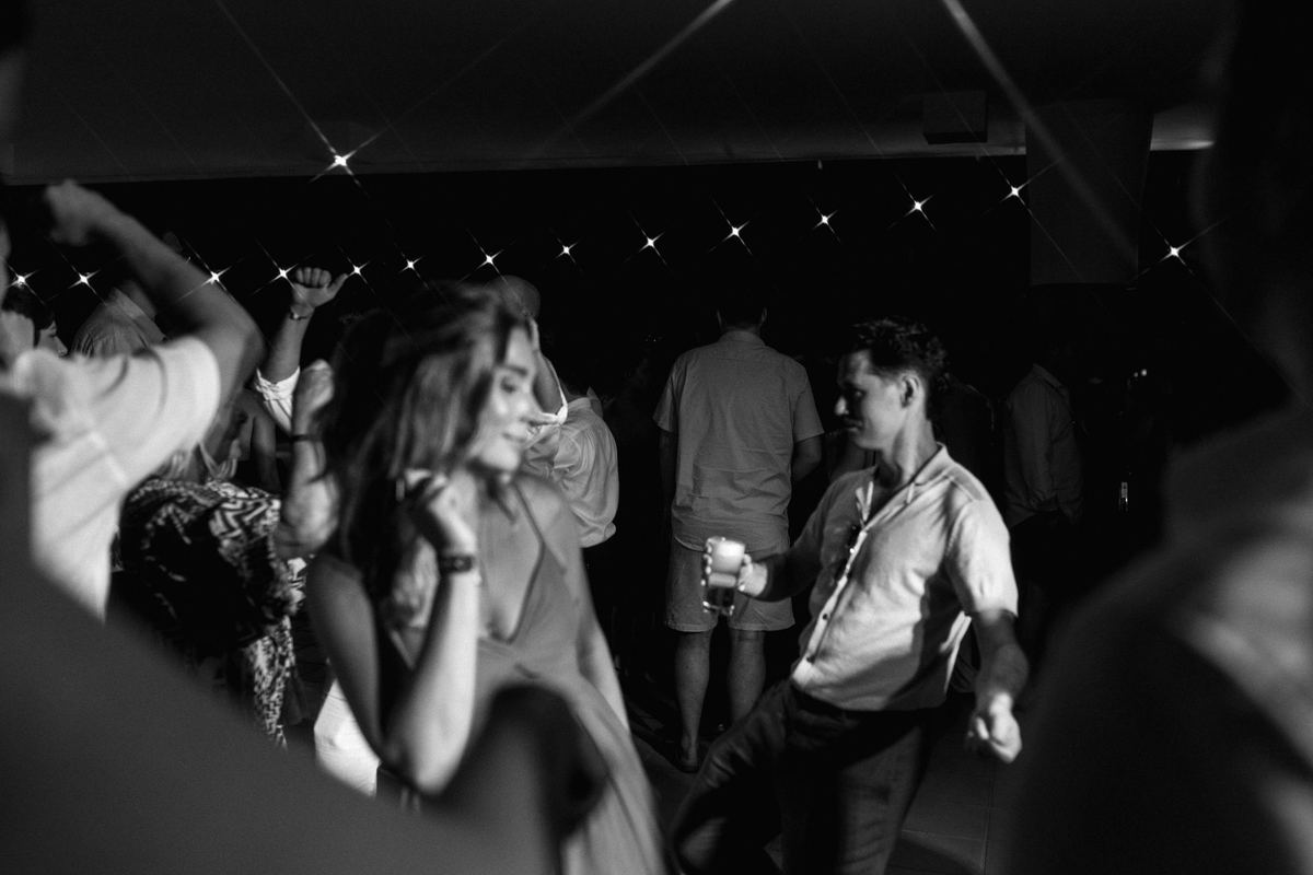 Bride laughing with guests during reception, candid wedding photography