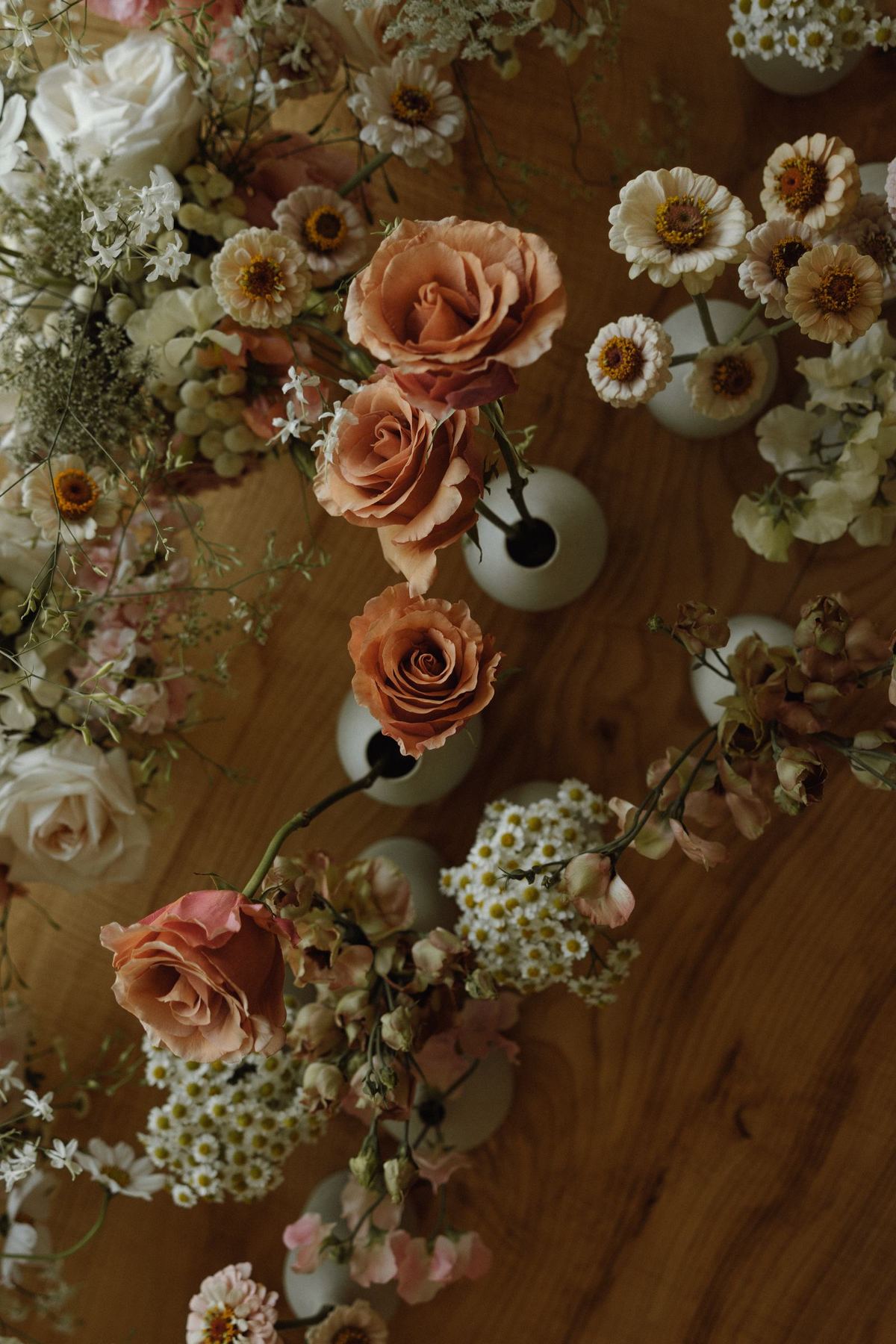 Overhead flat lay of the wedding flowers on a wooden table