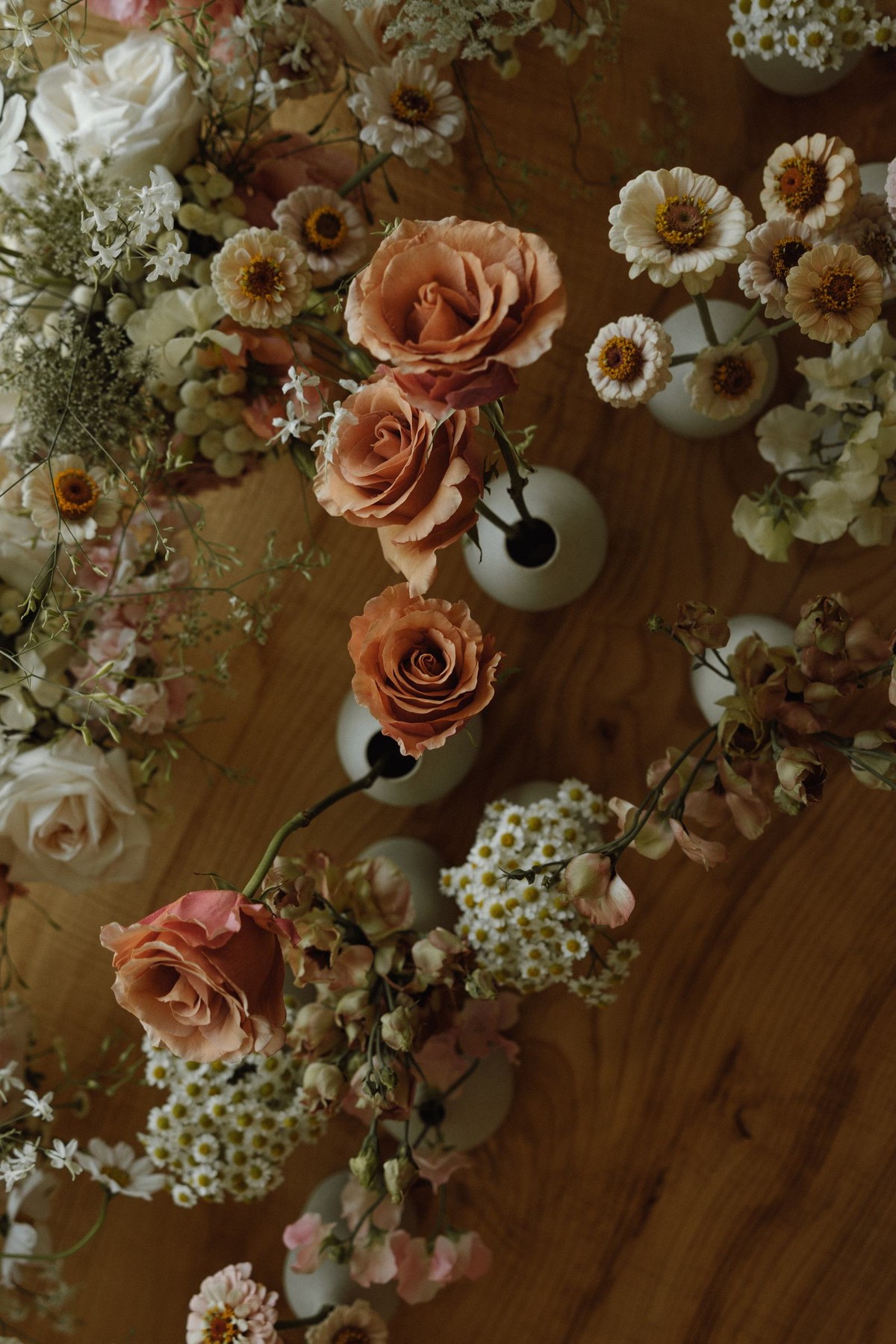 Overhead flat lay of the wedding flowers on a wooden table