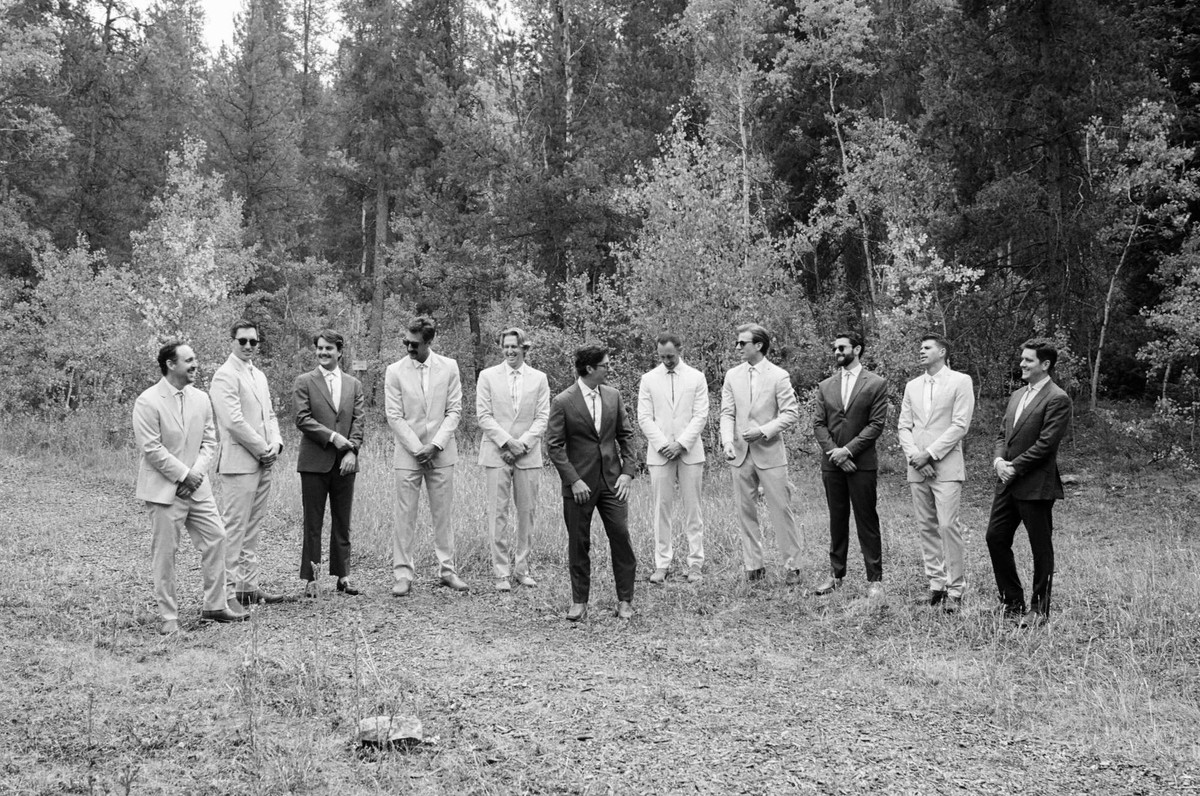 Owen and his groomsmen lined up in the meadow, shot on film at a mountain ranch among the aspens, black and white