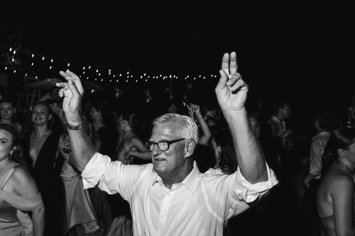 Paige's father dances under the string lights on Hawkins Island, Bermuda, black and white